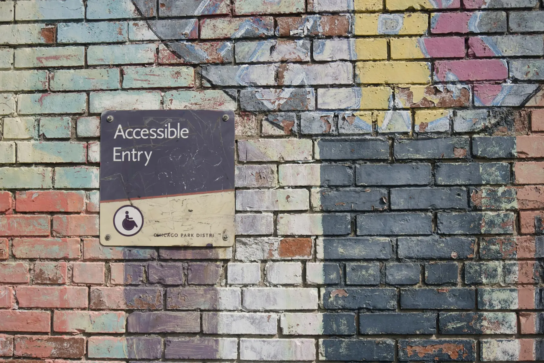 Developer reviewing Shopify theme code on a laptop while checking storefront accessibility