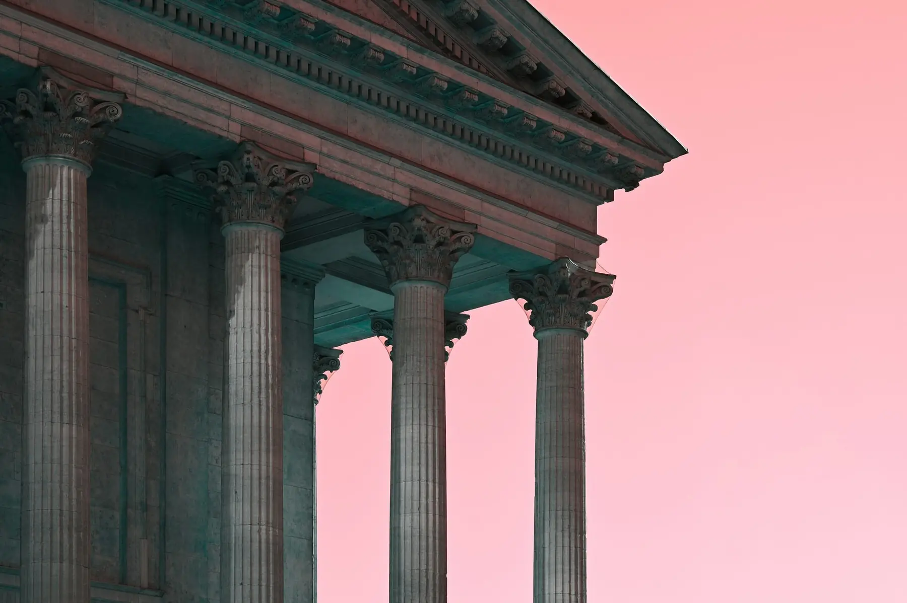 Classical stone portico with columns against a pink sky, suggesting the older classic customer account structure Shopify is retiring