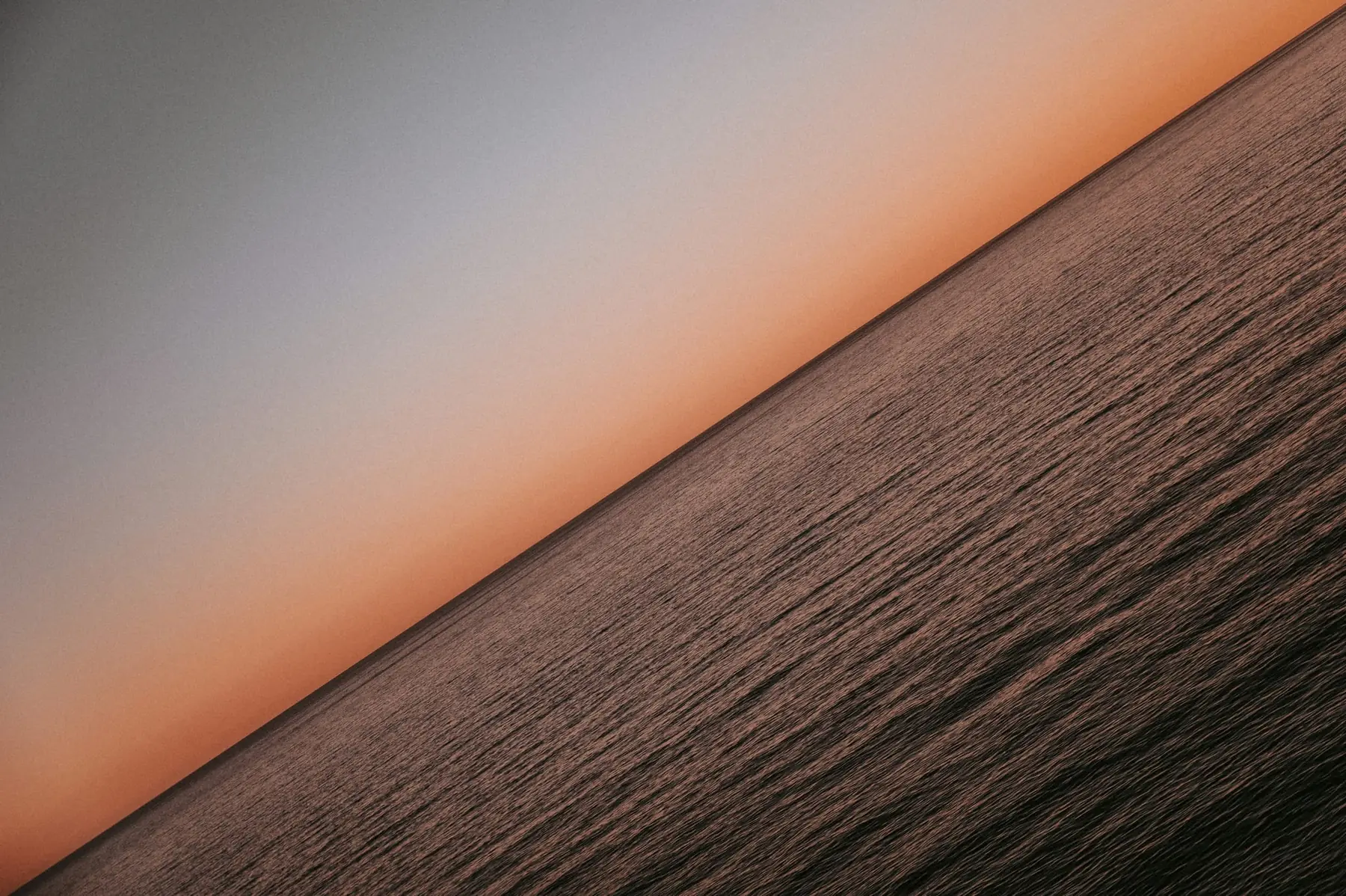 Calm horizon where dark water meets a pale sky, suggesting the £135 UK VAT threshold Shopify Tax now draws from fulfilment location