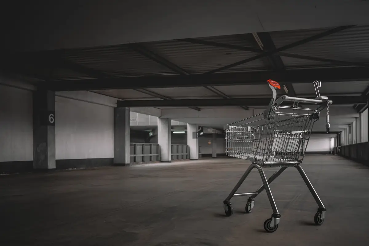 Shopify merchant reviewing checkout abandonment analytics on a laptop with funnel metrics showing add to cart and checkout starts but zero completed purchases
