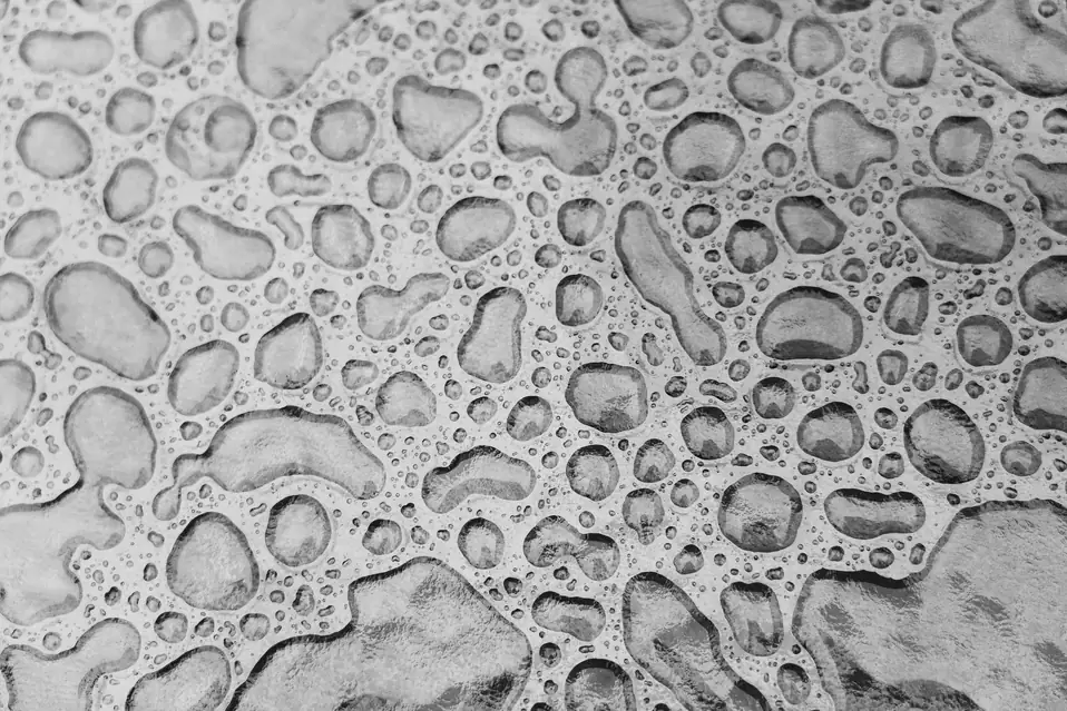 Close-up of water droplets on a textured surface, standing in for Shopify Sidekick task experts as isolated specialist models around a frontier planner